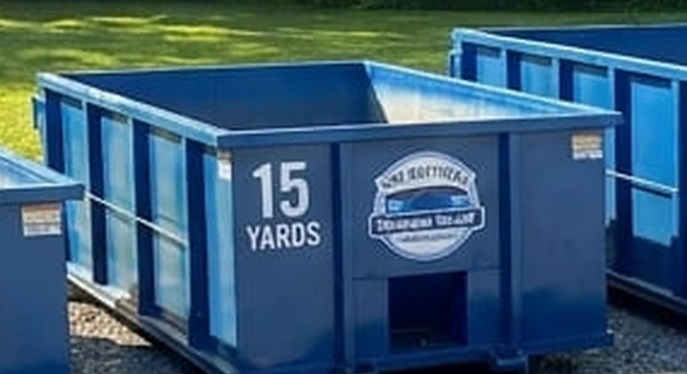 A clean, correctly-labeled 15 yard HNV Brothers Dumpster Rental roll-off container staged at the company yard